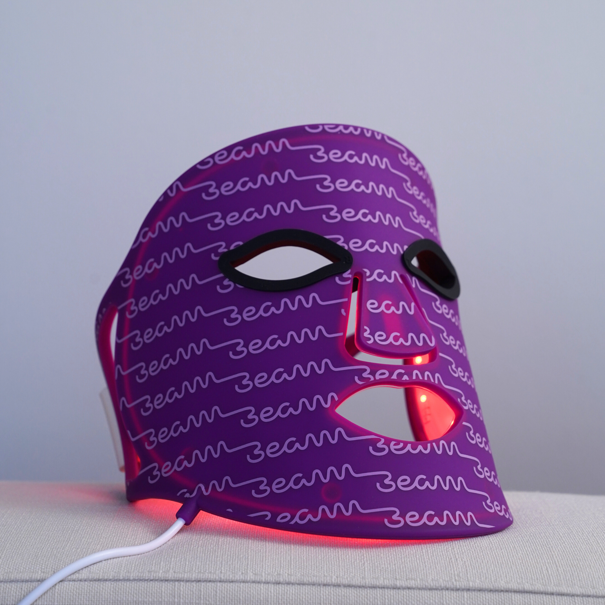 Innovative red light therapy mask by beam-wellness, displaying its full-spectrum LEDs and comfortable head strap design.