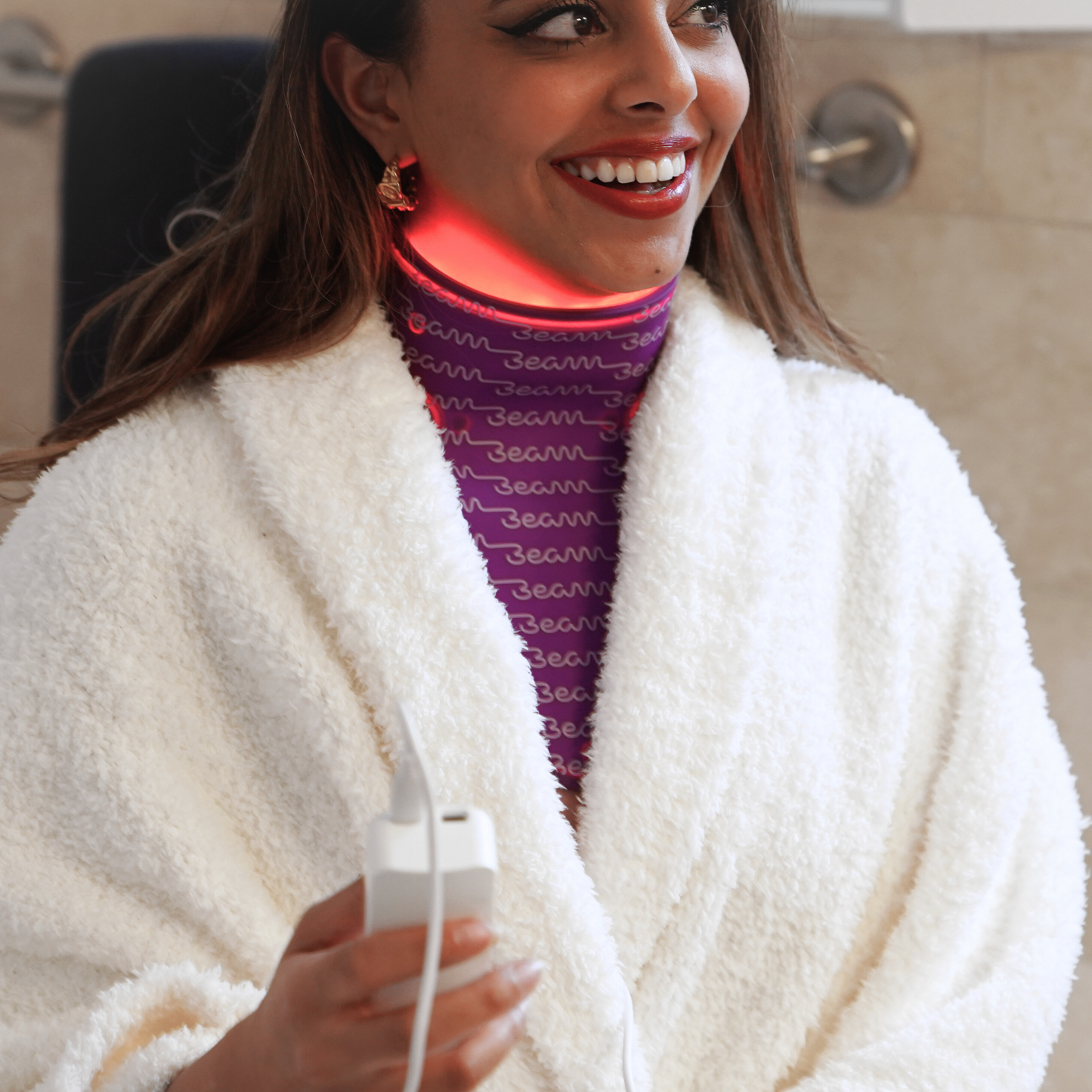 "User wearing the beam-wellness neck therapy mask, showcasing its ease of use and fit, designed for enhancing skin health around the neck area.